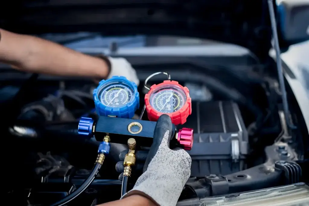 Car air conditioning regas gauges connected to engine